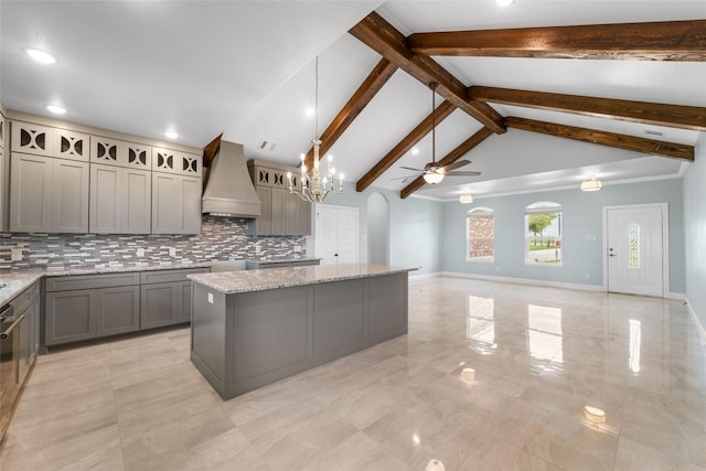 kitchen featuring premium range hood, gray cabinetry, a center island, and hanging light fixtures