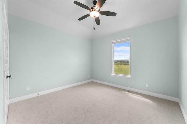 carpeted empty room with ceiling fan and vaulted ceiling