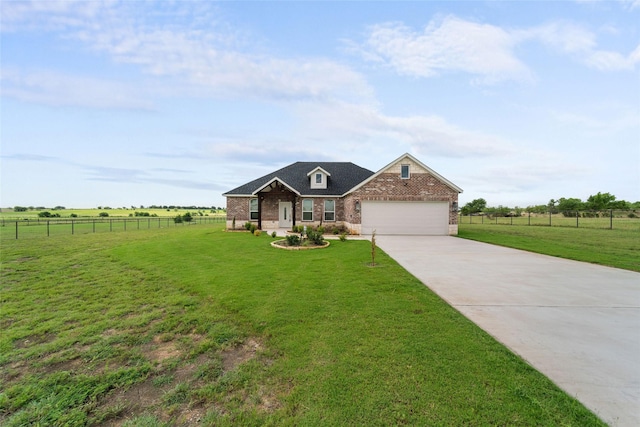 view of front of home featuring a garage, a rural view, and a front yard