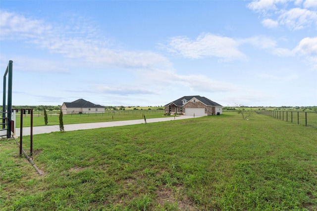 view of yard featuring a rural view and a garage