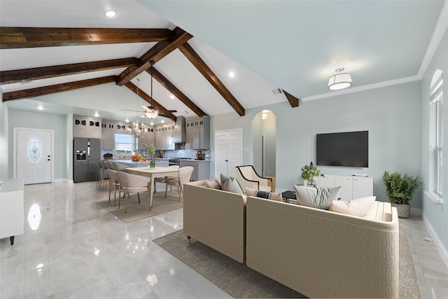 living room featuring a notable chandelier, beam ceiling, and high vaulted ceiling