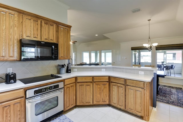 kitchen featuring stainless steel oven, backsplash, kitchen peninsula, electric cooktop, and ceiling fan with notable chandelier