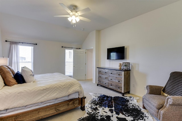 bedroom featuring ceiling fan, lofted ceiling, and light carpet