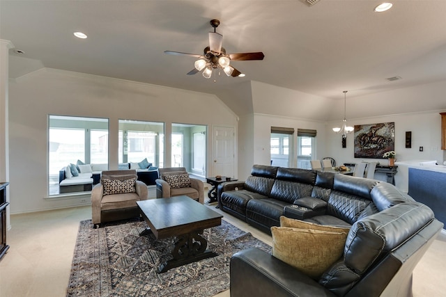 carpeted living room featuring crown molding, ceiling fan with notable chandelier, and vaulted ceiling