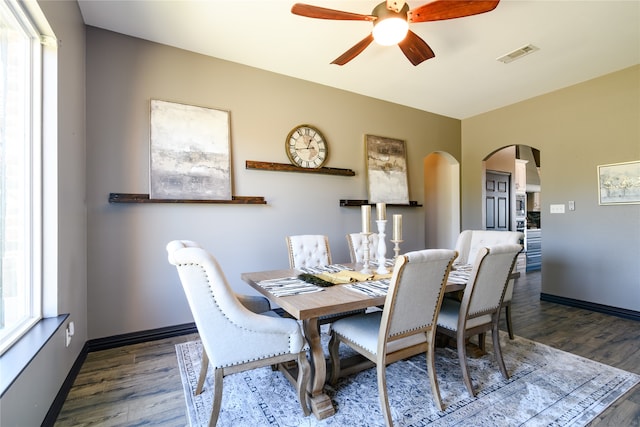 dining space featuring dark hardwood / wood-style flooring and ceiling fan