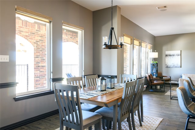 dining room featuring a notable chandelier and dark hardwood / wood-style floors