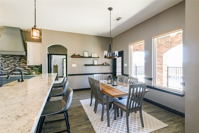 dining space with dark wood-type flooring