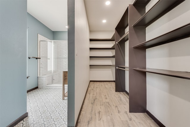 spacious closet featuring light hardwood / wood-style flooring