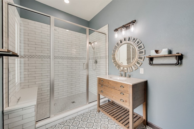 bathroom featuring tile patterned flooring, vanity, and a shower with shower door