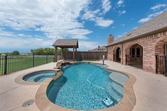 rear view of house featuring a lawn, a gazebo, and a patio area