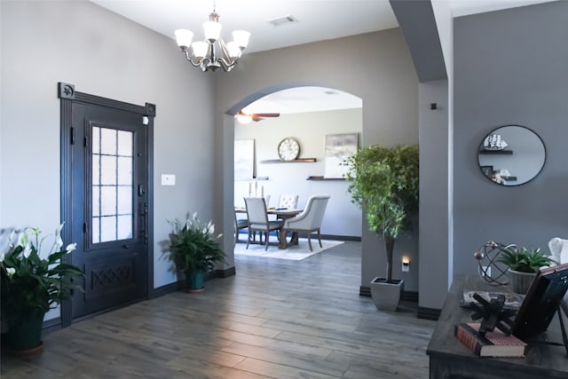 entrance foyer featuring dark wood-type flooring and ceiling fan with notable chandelier