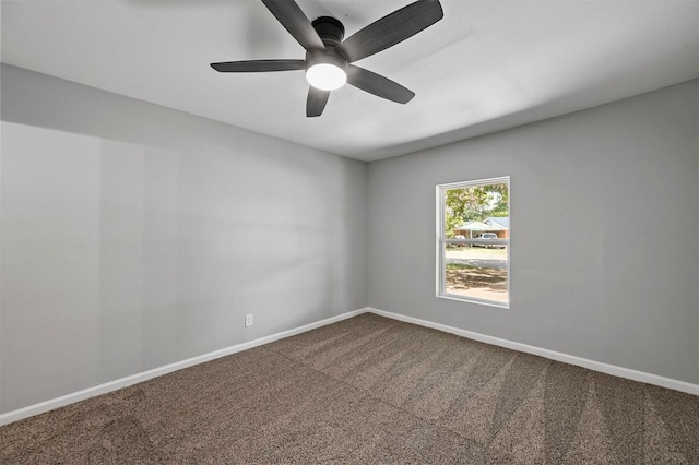 spare room featuring carpet and ceiling fan