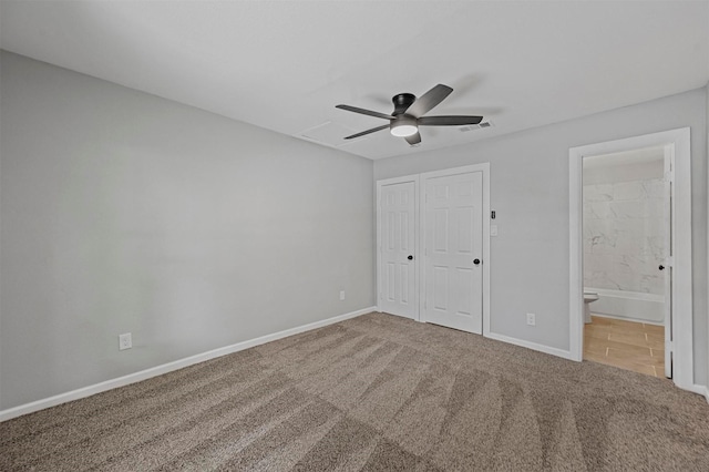 unfurnished bedroom featuring carpet, ensuite bathroom, a closet, and ceiling fan