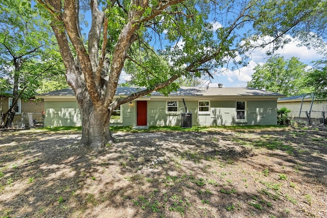 rear view of house featuring central AC