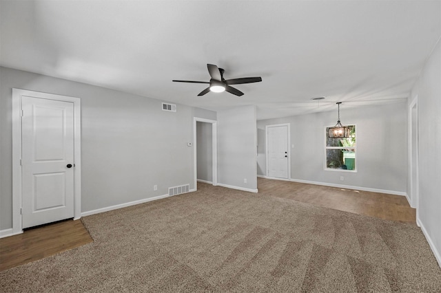 carpeted spare room with ceiling fan