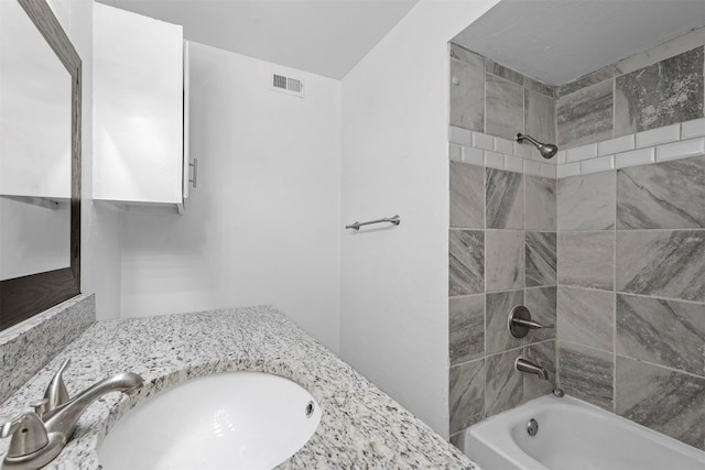 bathroom featuring tiled shower / bath and sink