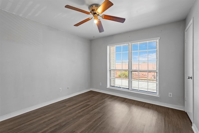 spare room featuring ceiling fan and dark wood-type flooring