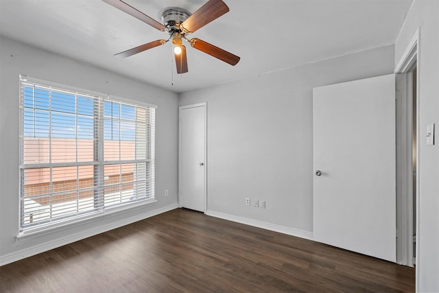 unfurnished bedroom featuring ceiling fan and dark hardwood / wood-style floors