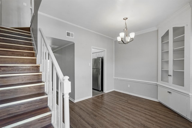 unfurnished dining area with ornamental molding, dark wood-type flooring, and a chandelier