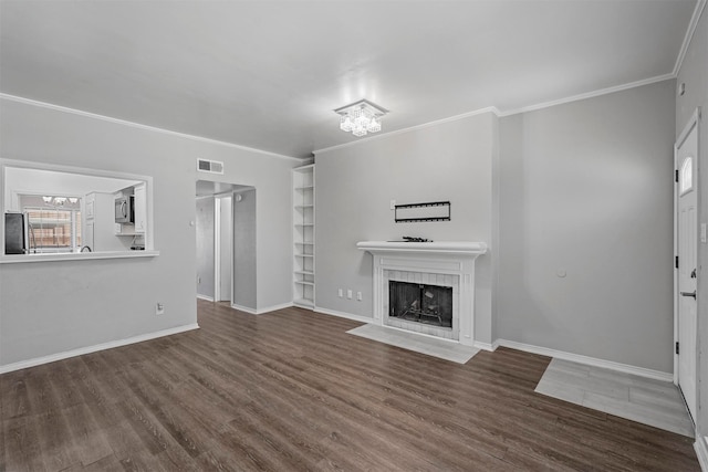 unfurnished living room featuring dark hardwood / wood-style floors and crown molding