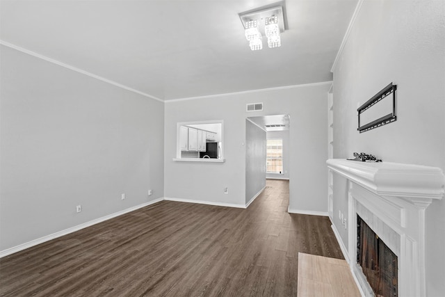 unfurnished living room featuring dark hardwood / wood-style flooring and crown molding