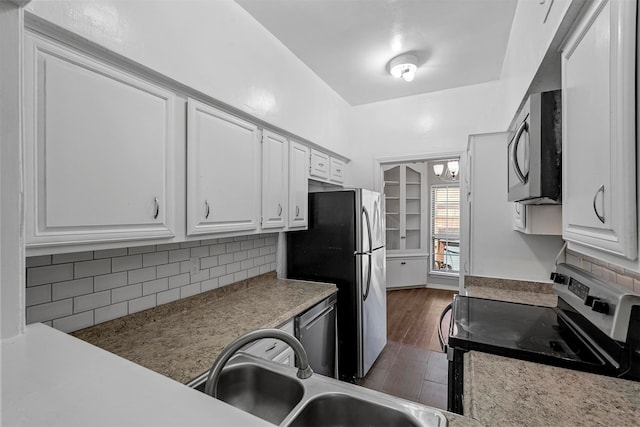 kitchen with backsplash, stainless steel appliances, dark wood-type flooring, sink, and white cabinetry