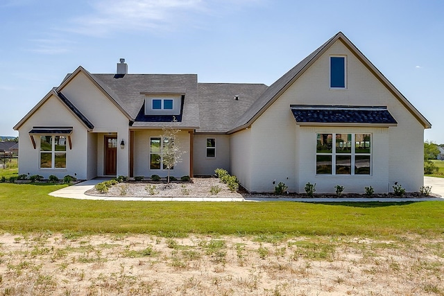 modern inspired farmhouse with a front lawn