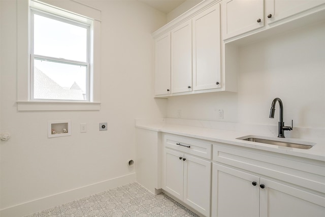 laundry area with hookup for a washing machine, hookup for an electric dryer, cabinets, and sink