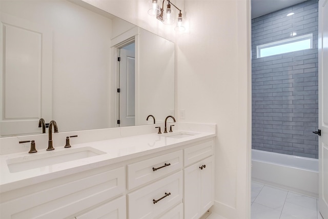 bathroom featuring tiled shower / bath combo, vanity, and tile patterned flooring