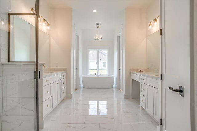 bathroom featuring a tub to relax in, an inviting chandelier, tile patterned flooring, and dual bowl vanity