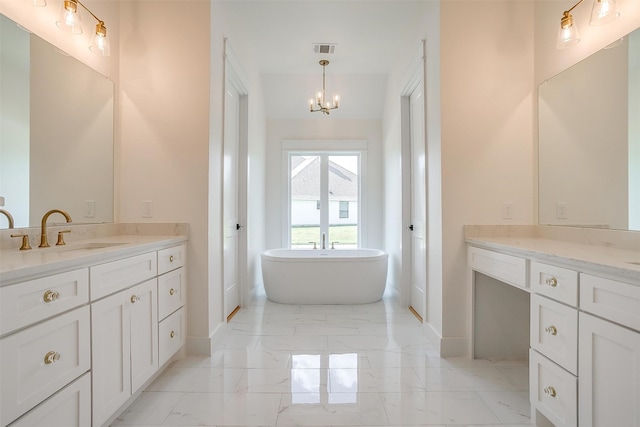 bathroom featuring tile patterned flooring, a bath, a chandelier, and vanity