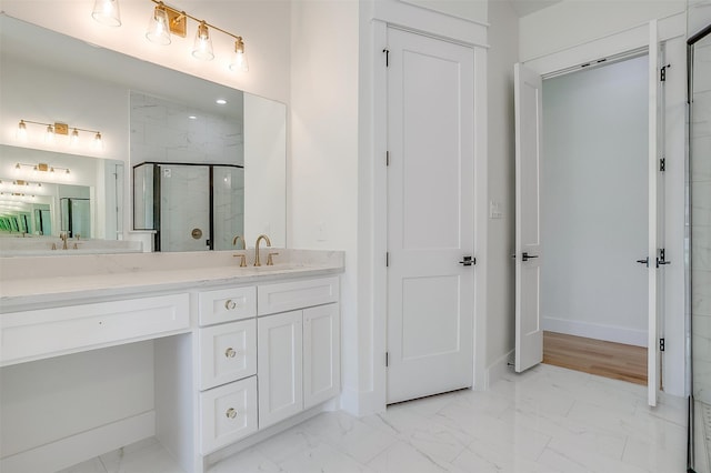 bathroom featuring a shower with shower door, tile patterned flooring, and dual bowl vanity