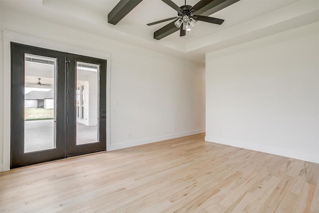 spare room with light wood-type flooring, ceiling fan, and french doors