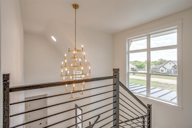 interior space featuring lofted ceiling and a chandelier