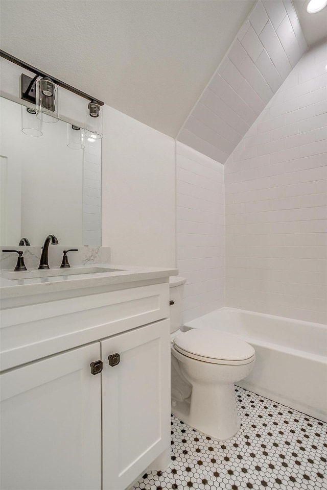 full bathroom with tile patterned flooring, toilet, vanity,  shower combination, and vaulted ceiling