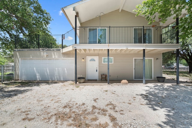 back of house featuring a garage