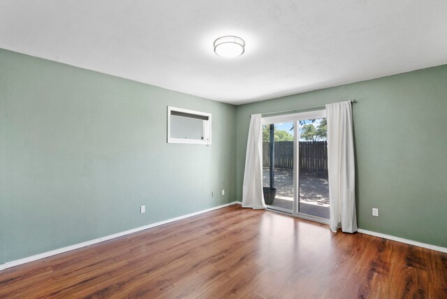 empty room featuring dark wood-type flooring