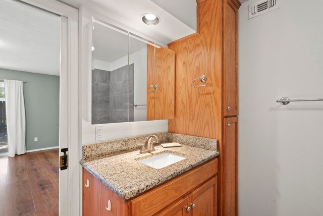 bathroom with vanity and hardwood / wood-style flooring