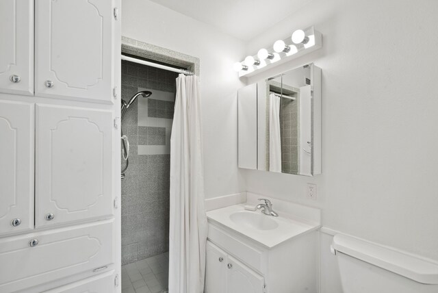 bathroom featuring vanity, toilet, and walk in shower