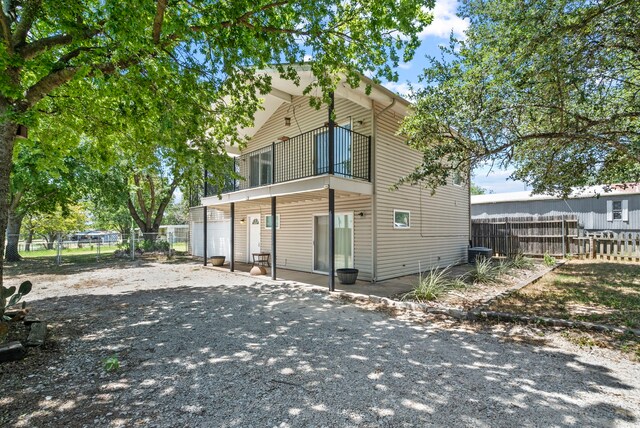 rear view of property with a balcony