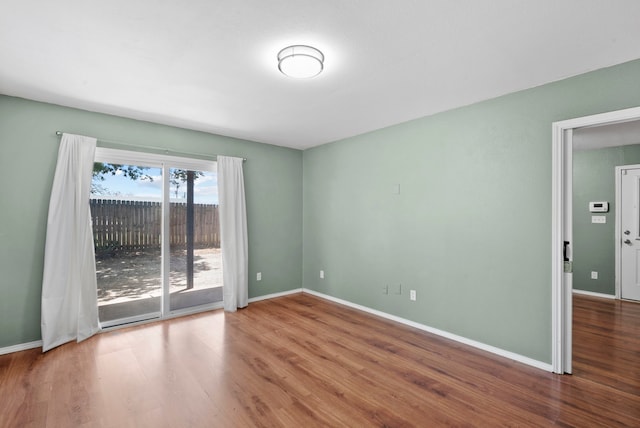 spare room with wood-type flooring