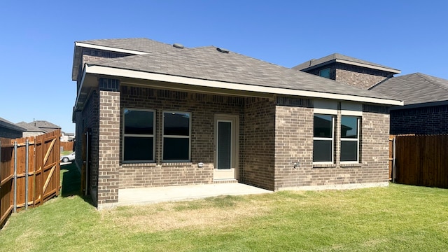 back of property featuring a lawn