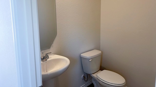 bathroom featuring toilet and sink