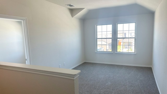 spare room featuring dark colored carpet