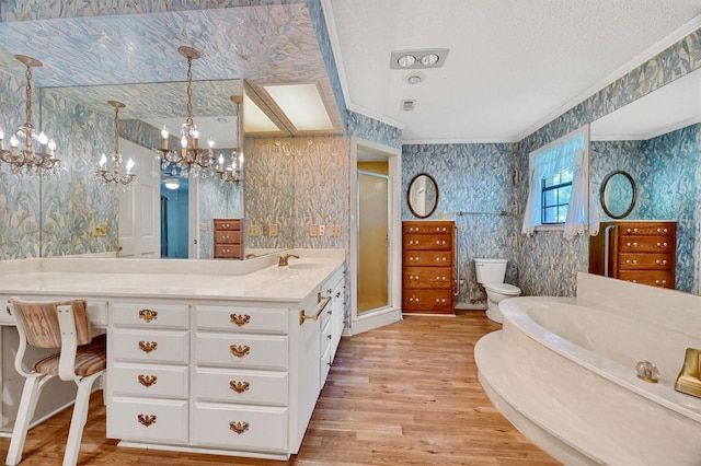 full bathroom with toilet, a notable chandelier, wood-type flooring, shower with separate bathtub, and crown molding