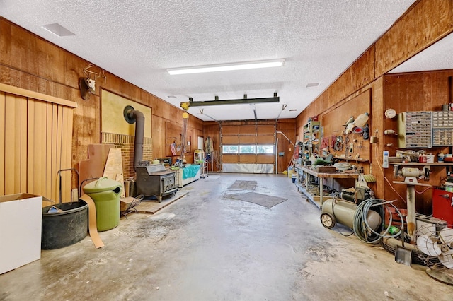 garage featuring a workshop area and wooden walls