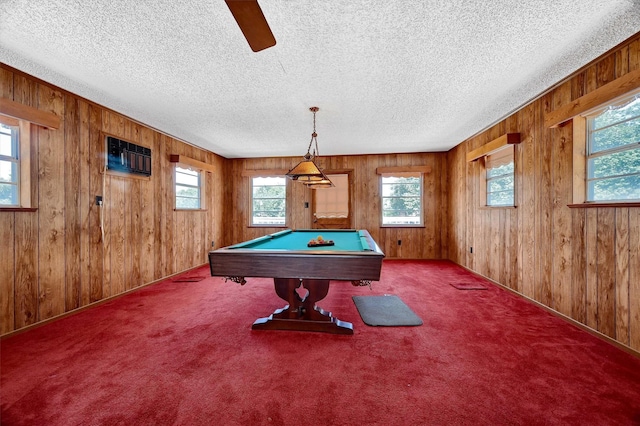 rec room featuring billiards, wood walls, a textured ceiling, and light colored carpet