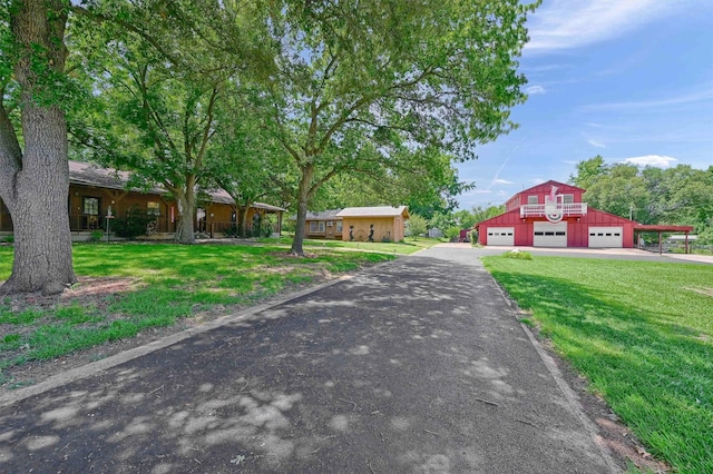 view of front facade featuring a front yard, a garage, and a carport