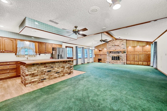 kitchen with plenty of natural light, light colored carpet, stainless steel fridge with ice dispenser, and lofted ceiling with beams