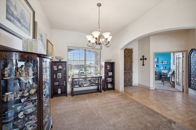 interior space featuring a chandelier and carpet